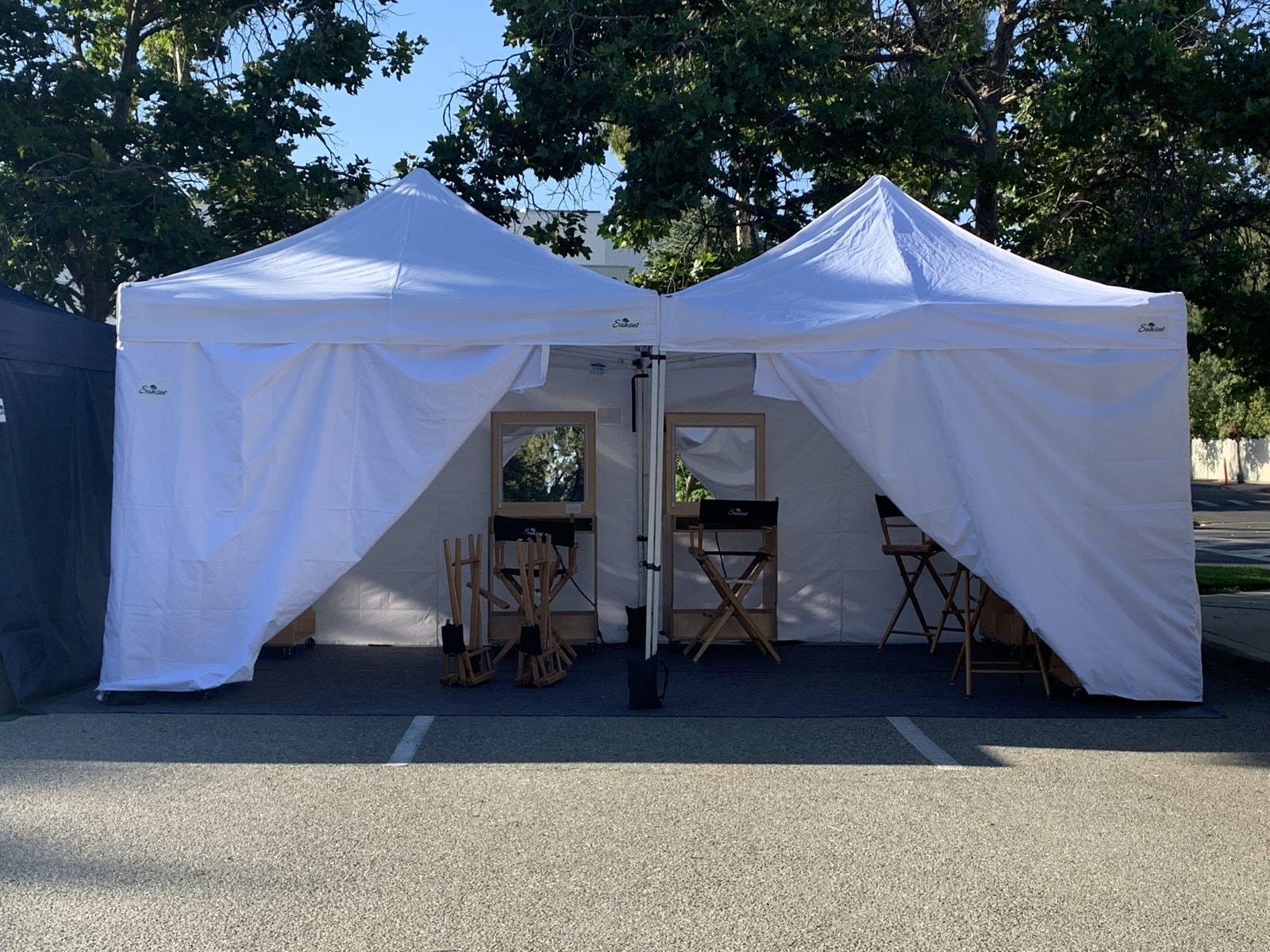 White changing tent with director chairs on location